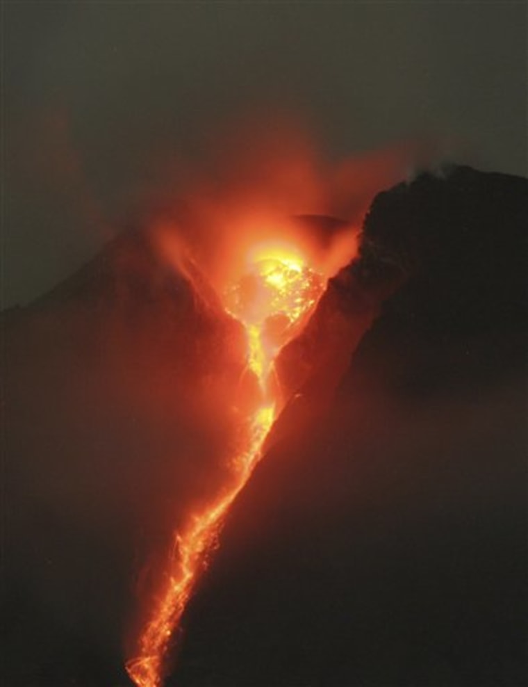 In this late Tuesday, Nov. 2, 2010 photo, lava glows at the crater of Mount Merapi as seen from Deles, Central Java, Indonesia. Indonesia's most dangerous volcano is once again sending searing gas clouds and burning rocks down its scorched flanks. (AP Photo/Binsar Bakkara)